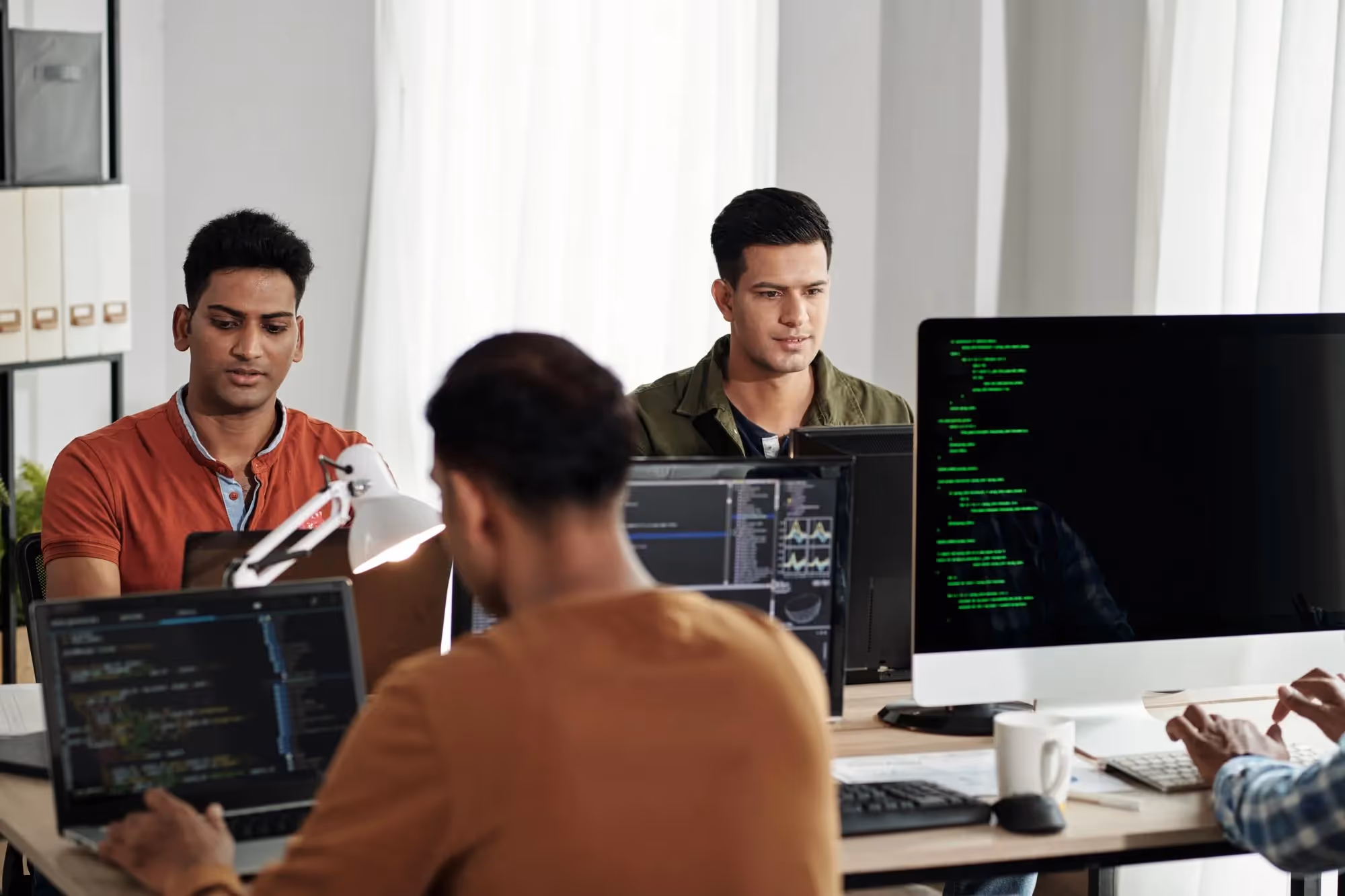 DevSecOps engineers working in the office.