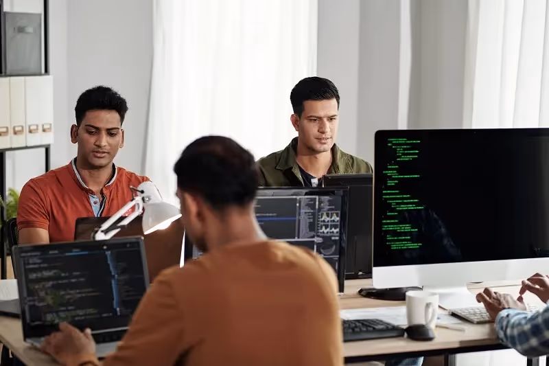 DevSecOps engineers working in the office.