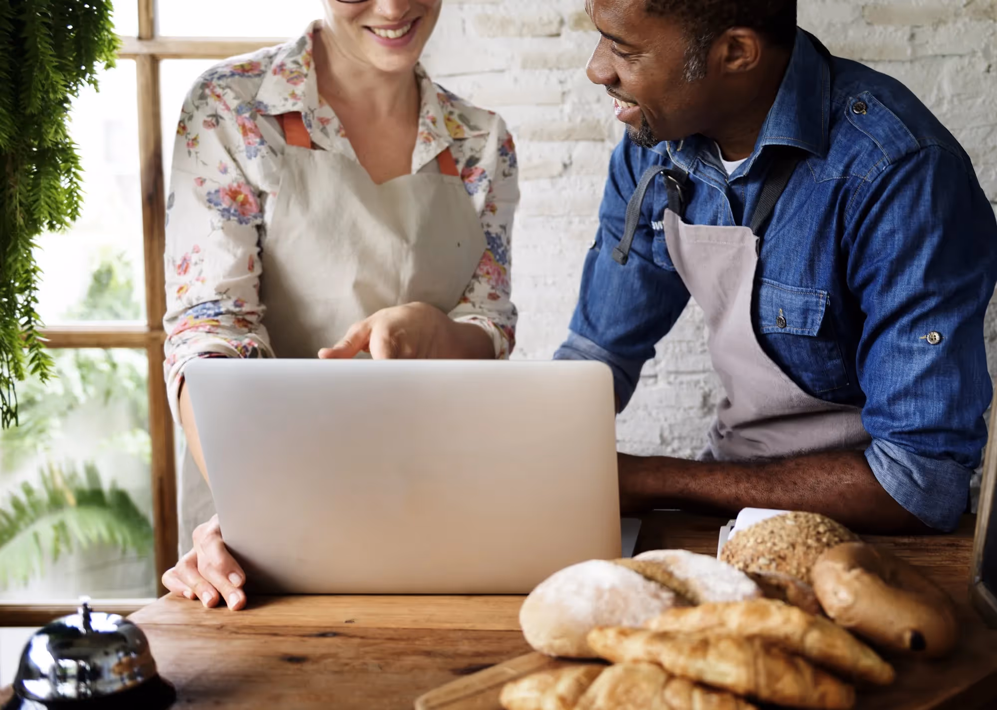 Bakery owners discussing business over a laptop.
