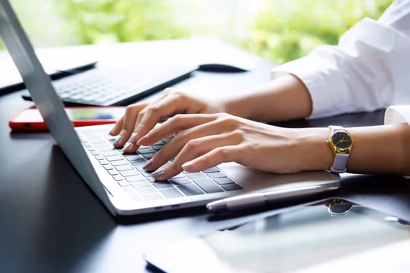 GRC consultant working on their laptop