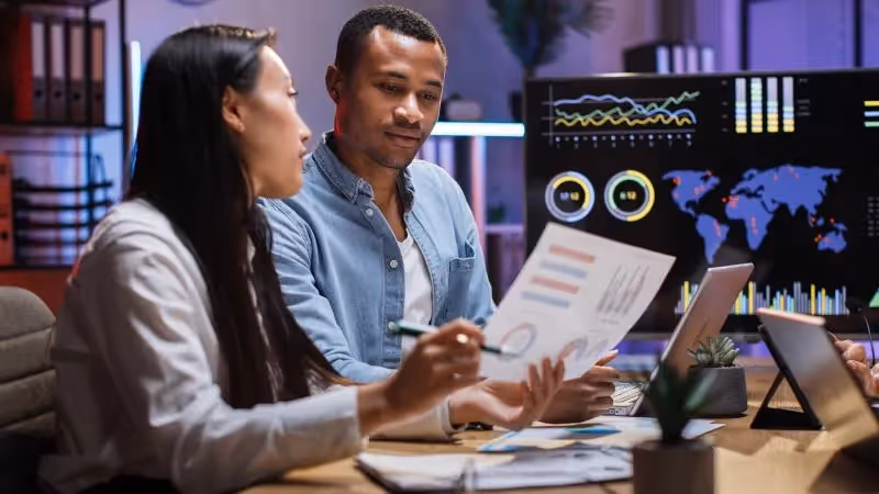 Photo of a digital transformation consulting firm employee discussing information technology strategy with a client.