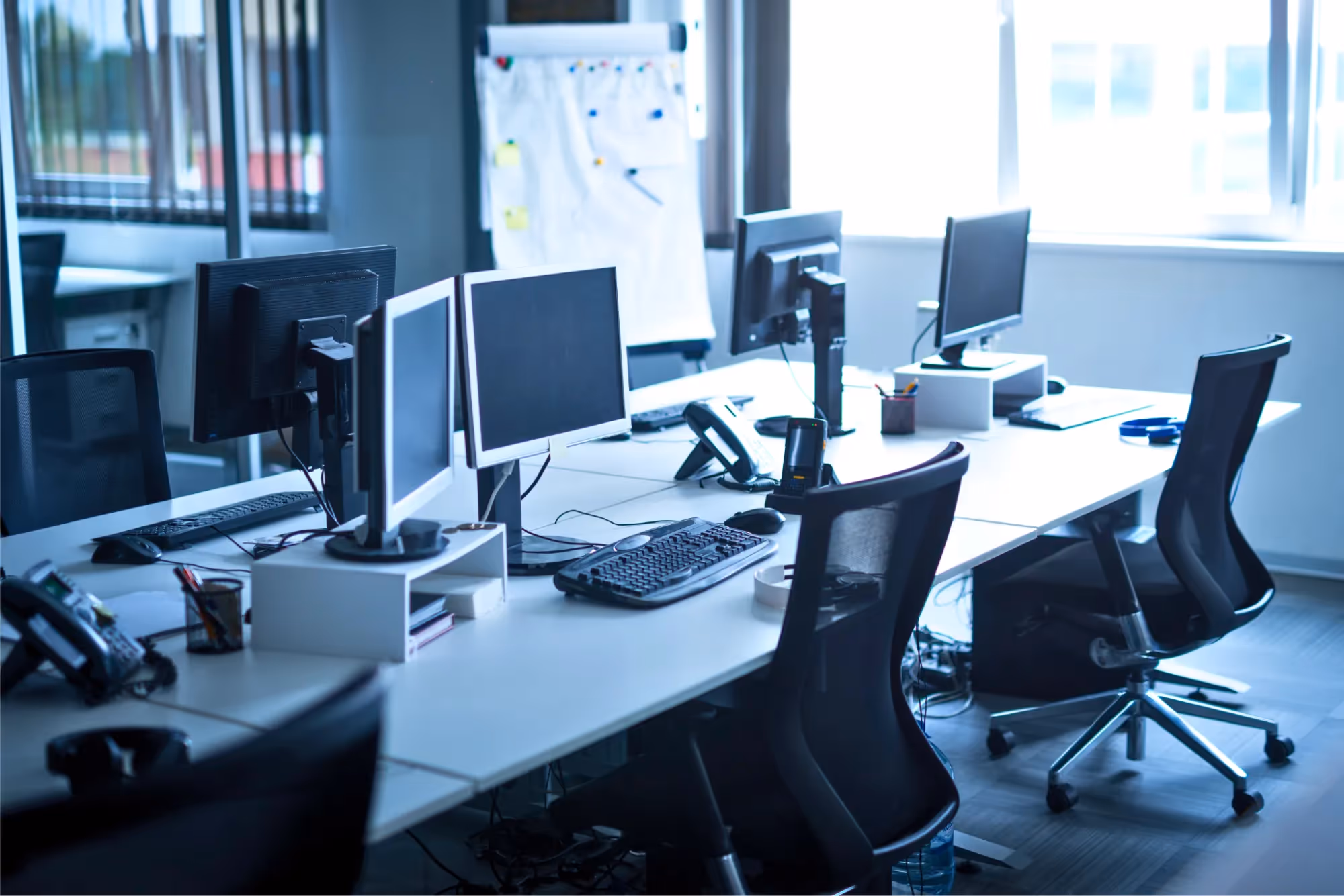 Picture of an empty office with computers.