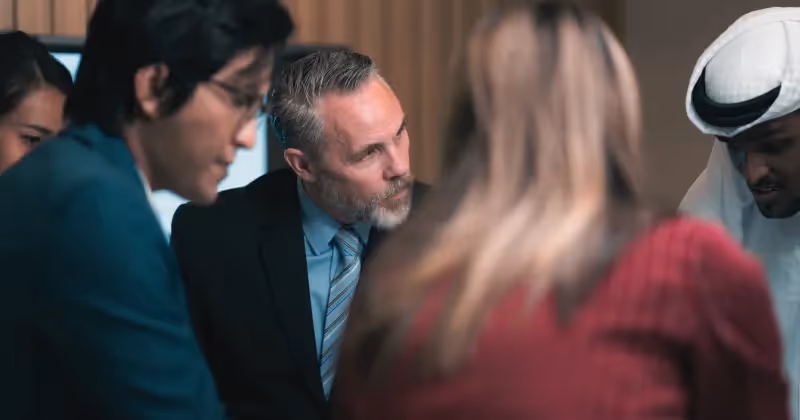 Photo of business partners discussing location strategy during a meeting at a company office.