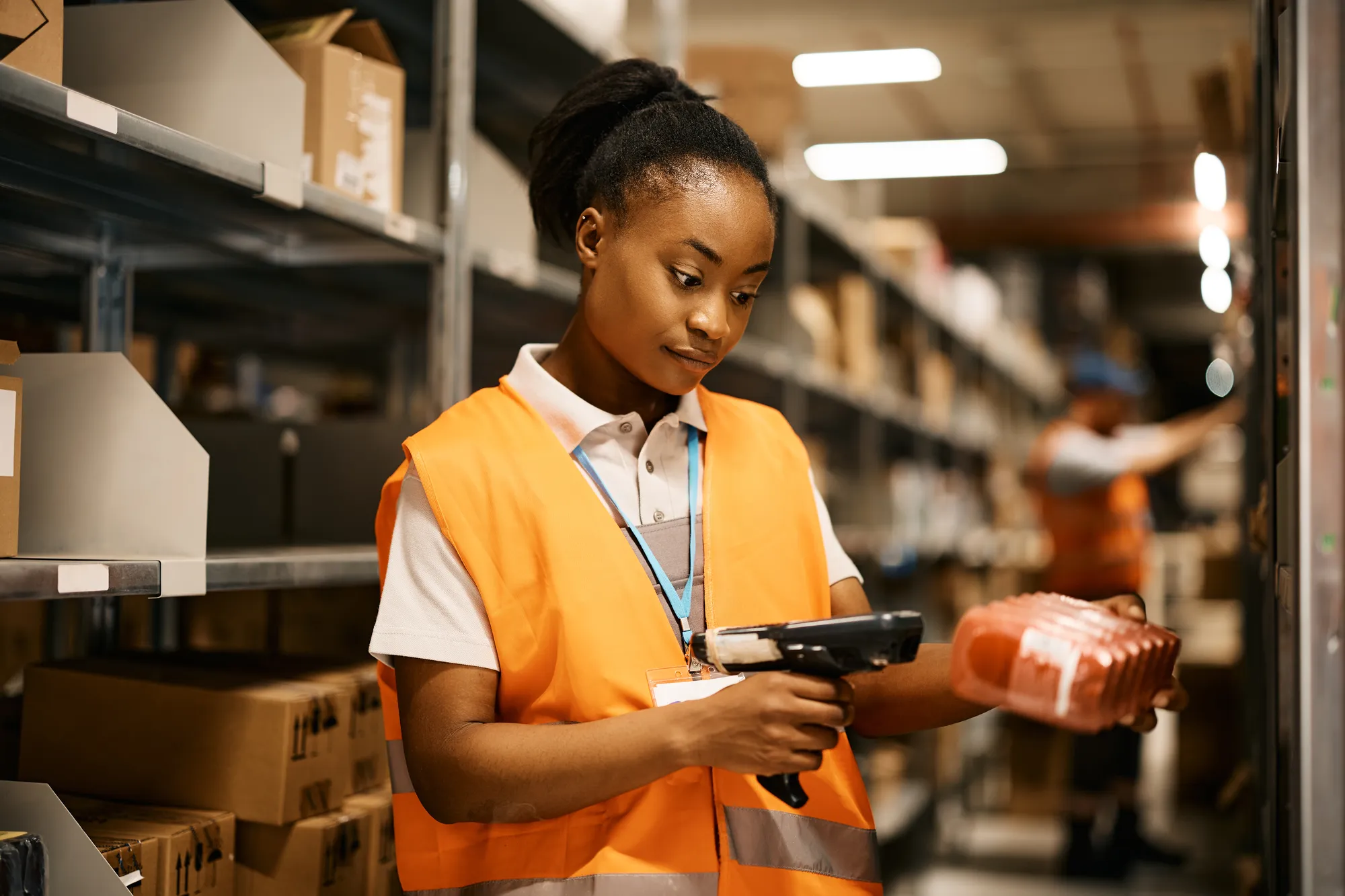 Warehouse worker scanning barcodes on packages