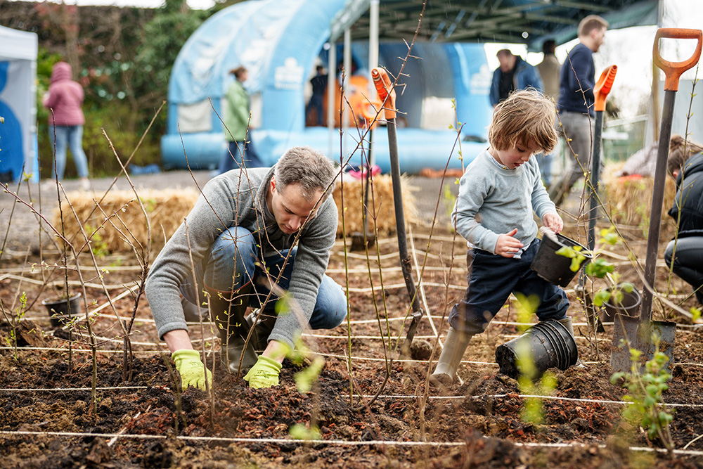 Father and son planting trees during the SOWoods planting day.