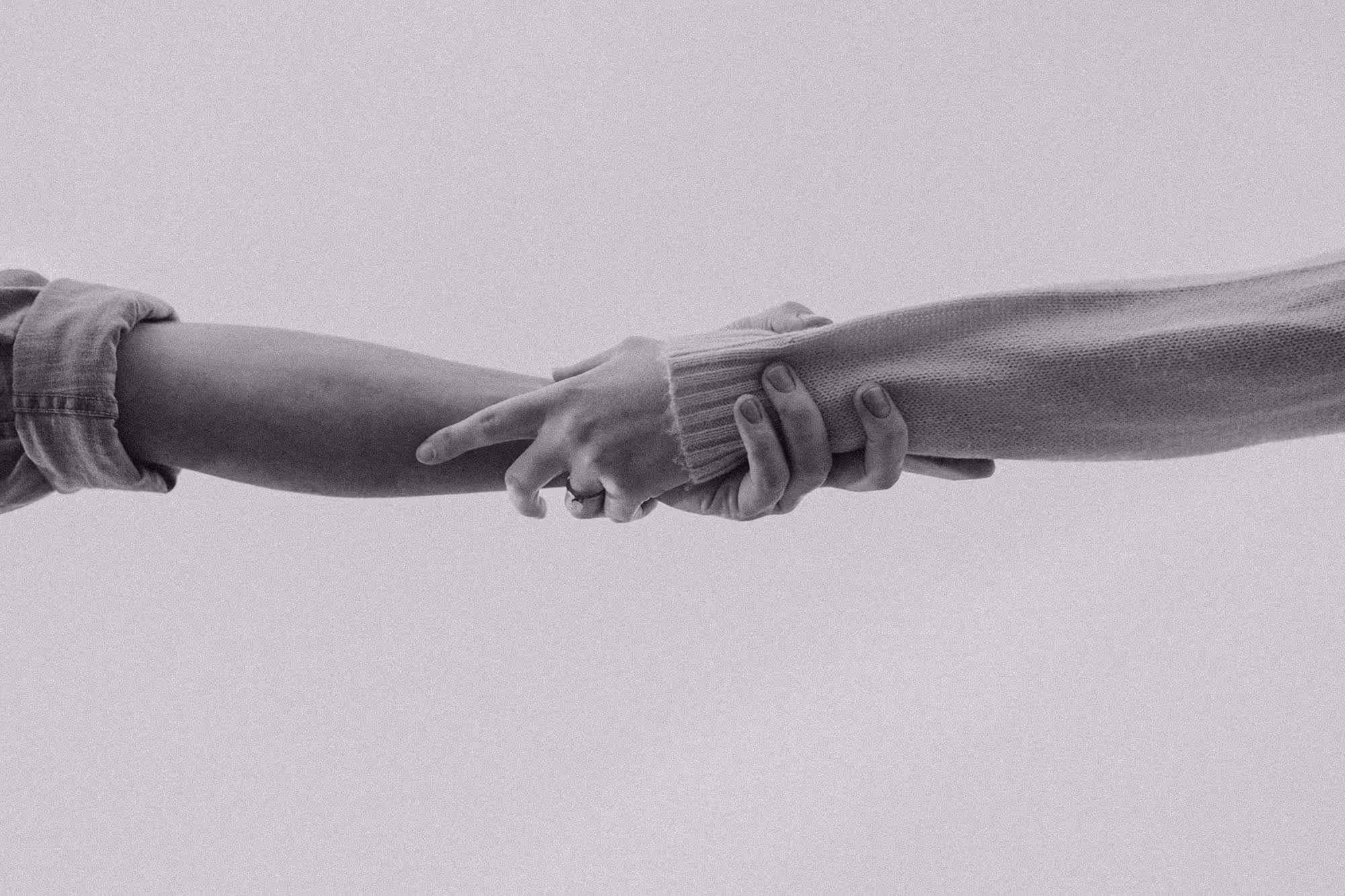 two hands supportively clasping each other