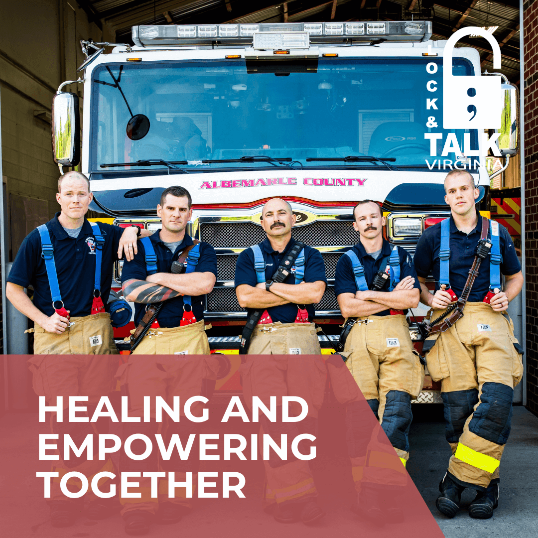 Five male firefighters standing in front of the fire engine looking at the camera.