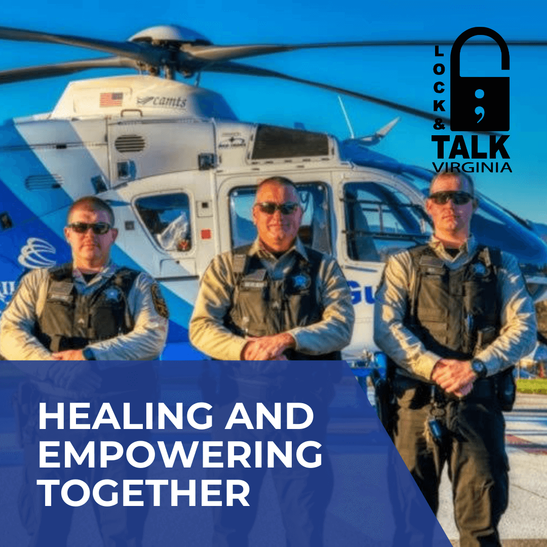 Three male police officers standing in front of a helicopter looking at the camera.