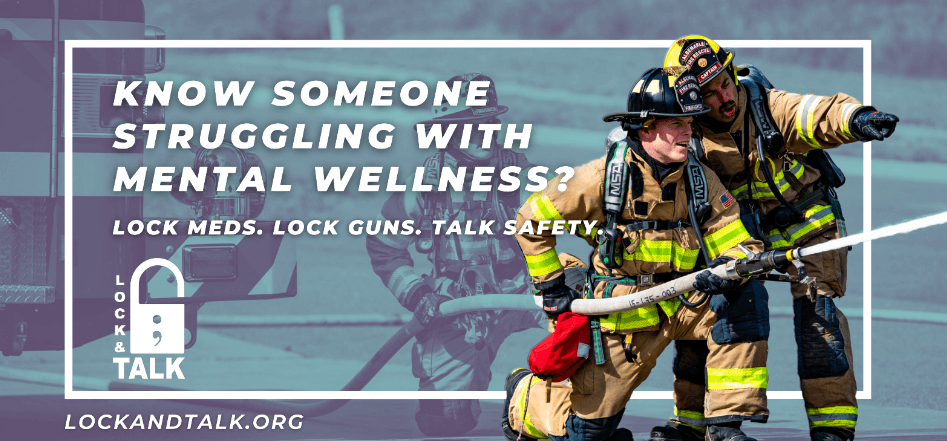 Male firefighters holding a hose