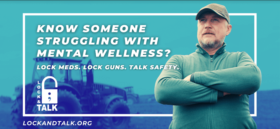 Farmer standing in field in front of tractor