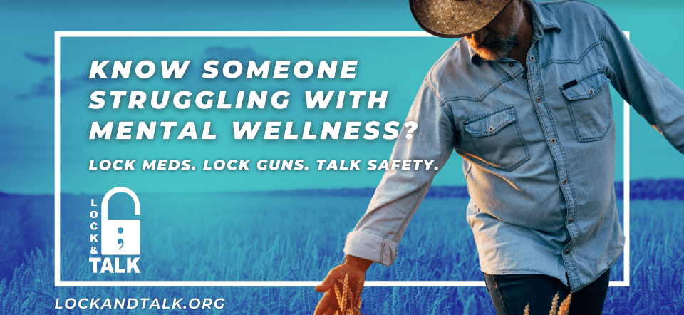 Farmer running hand through wheat field.