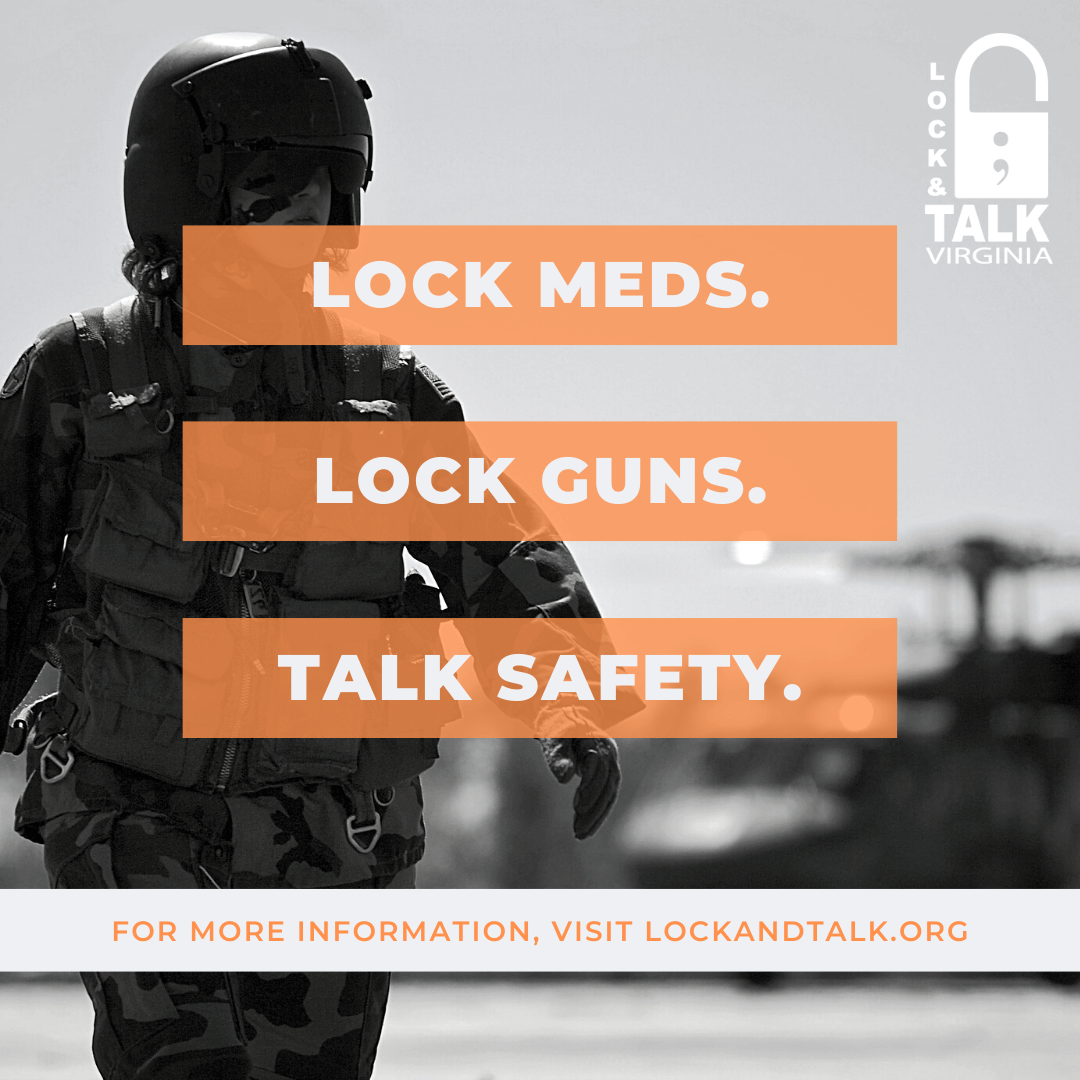 Military person walking in front of helicopter