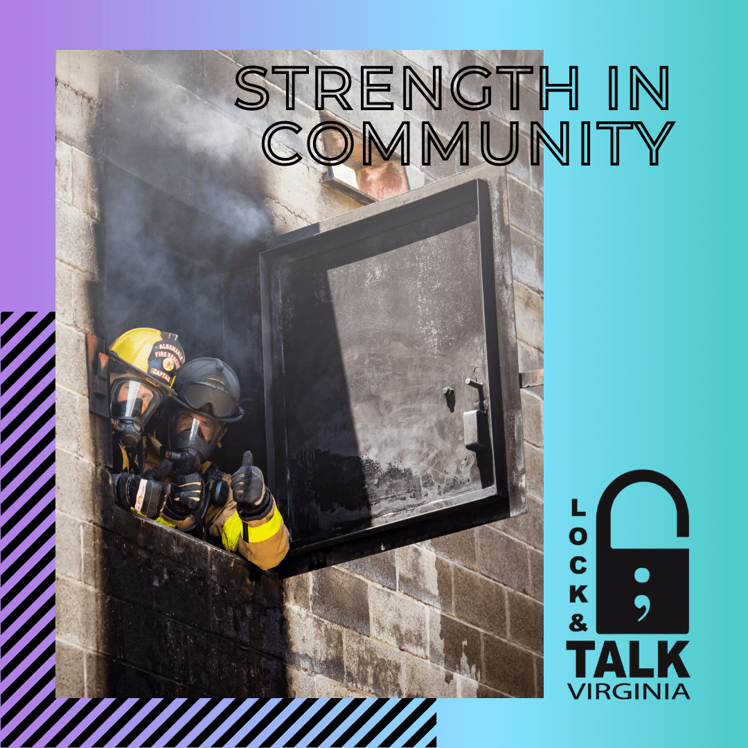 Two firefighters looking out of burning window giving the thumbs up