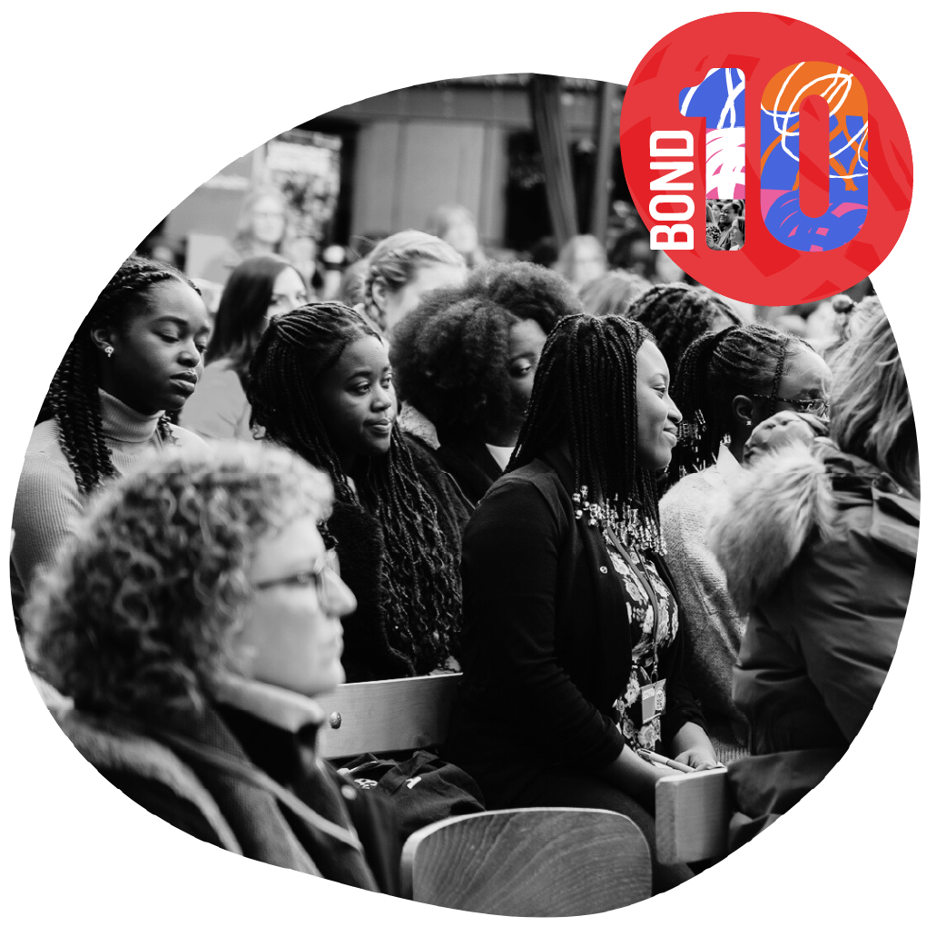 Women seated in audience smiling