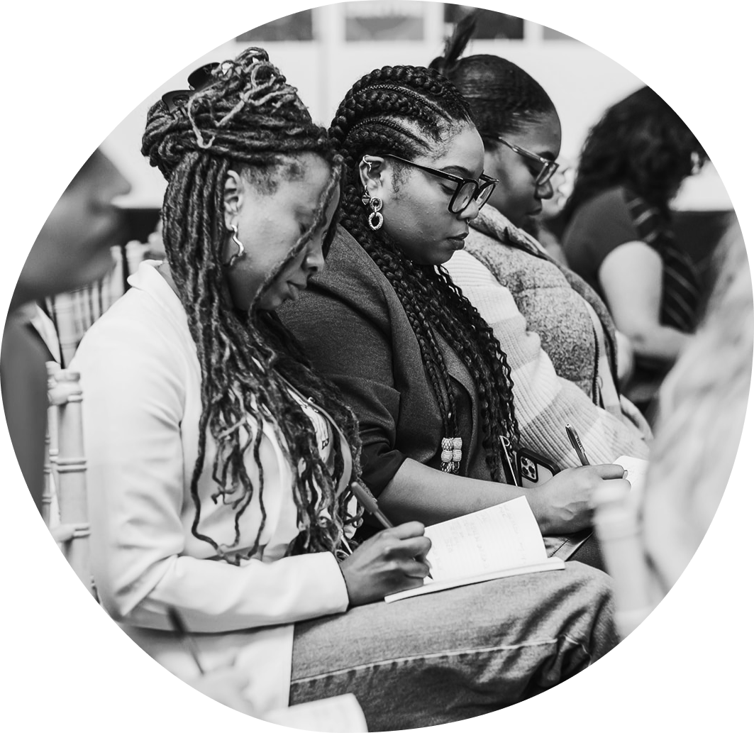 Women seated in audience smiling