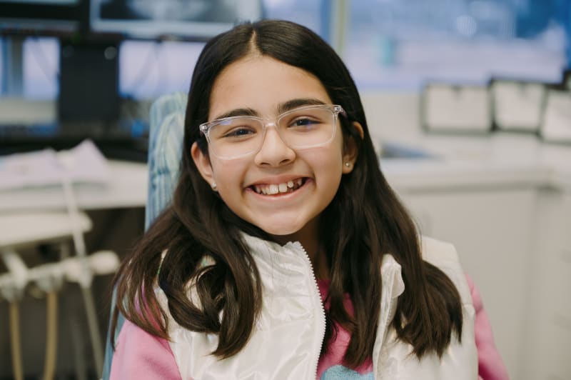 Smiling adolescent girl with healthy teeth showing confident, happy smile