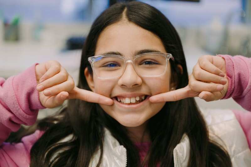 Child receiving painless dental treatment with modern numbing techniques at pediatric dental clinic