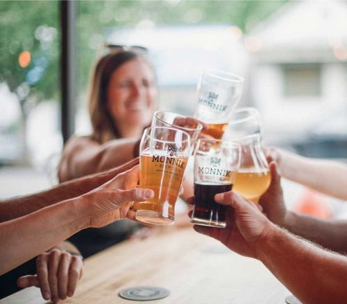 group of people clinking beer glasses
