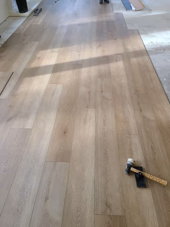 Luxury vinyl plank flooring installation in a living room