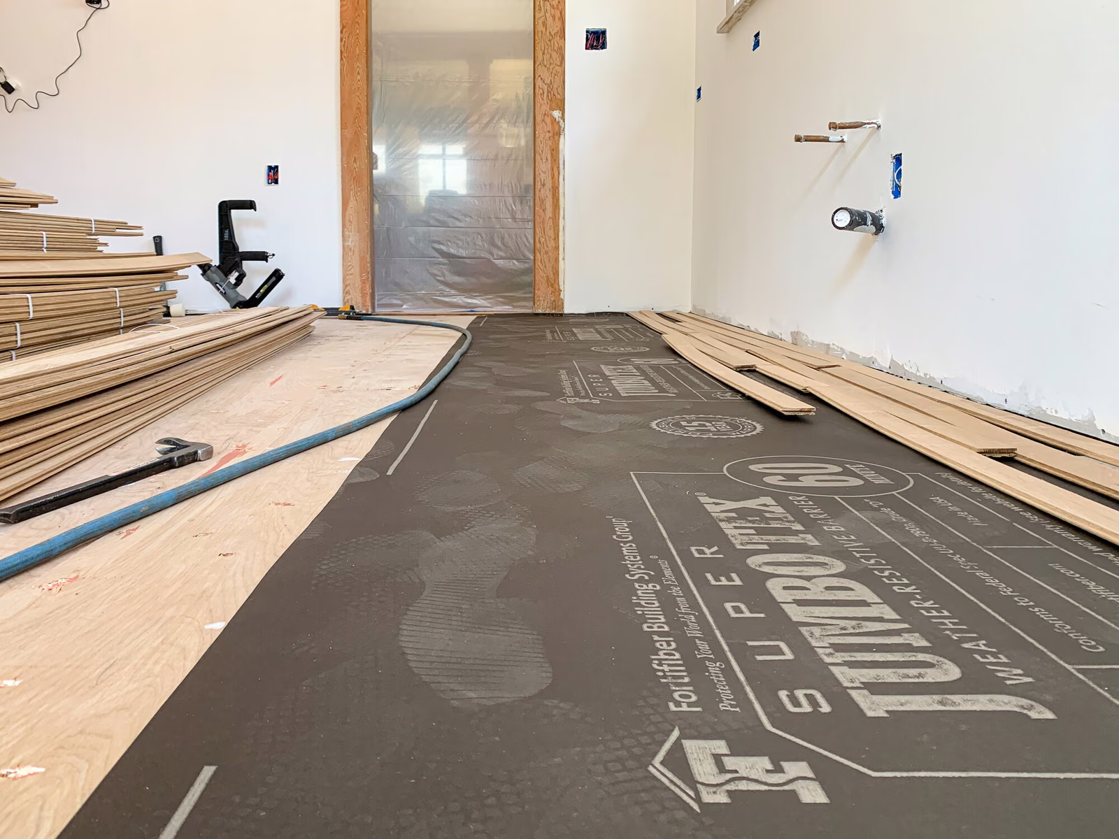 New white oak tongue-and-groove hardwood being installed in an older Snohomish County home