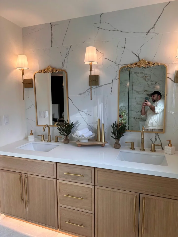 Double vanity against a white marble-look porcelain slab wall