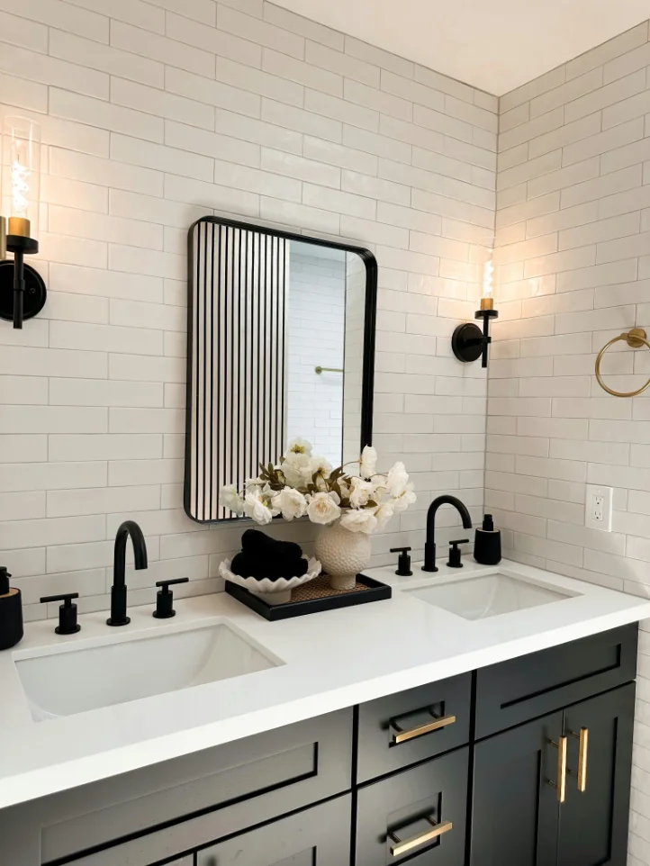 White subway tile covering a full bathroom vanity wall and corner