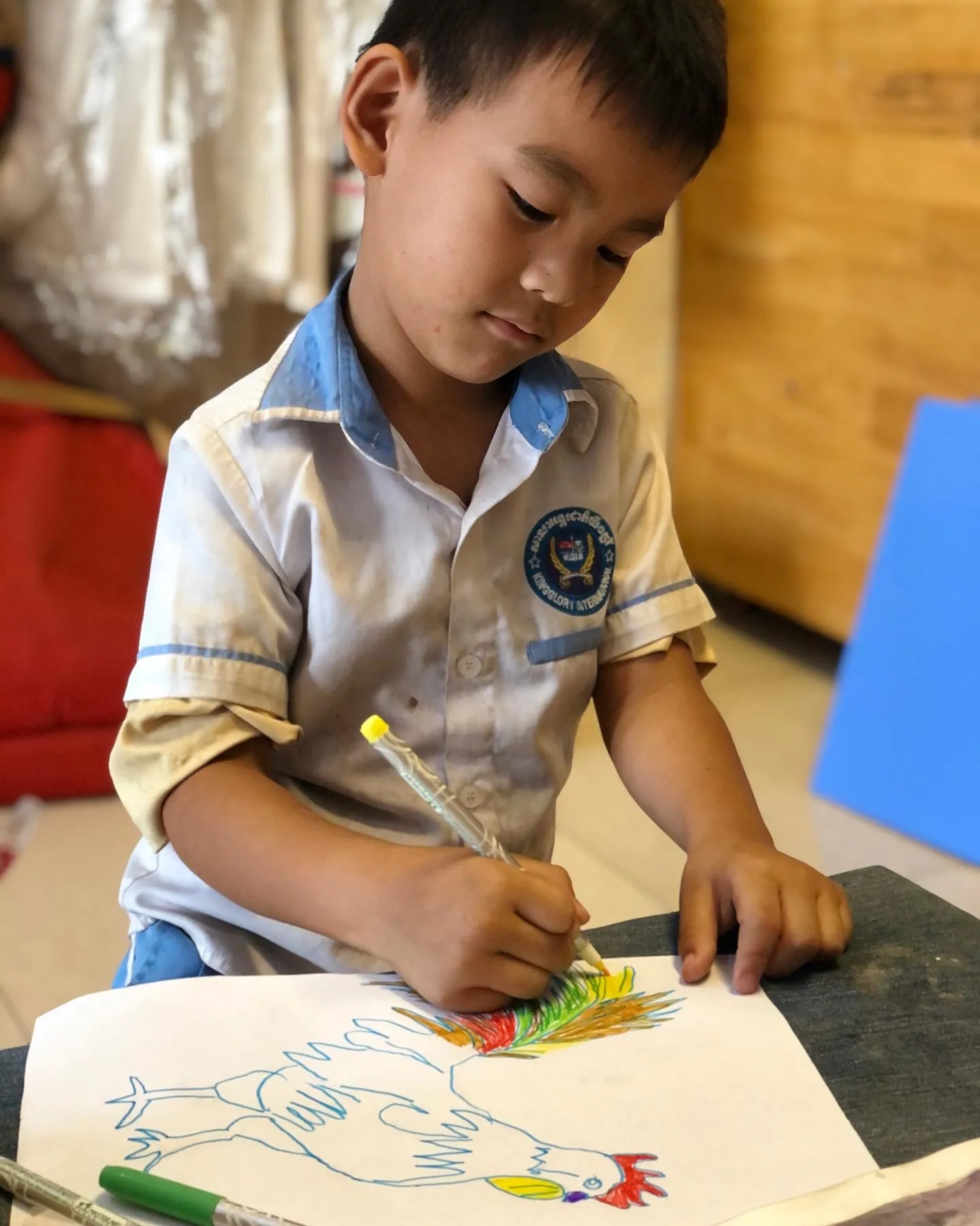 Art Will Save the World student coloring in a picture.
