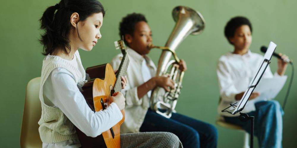 children practising on various musical instruments