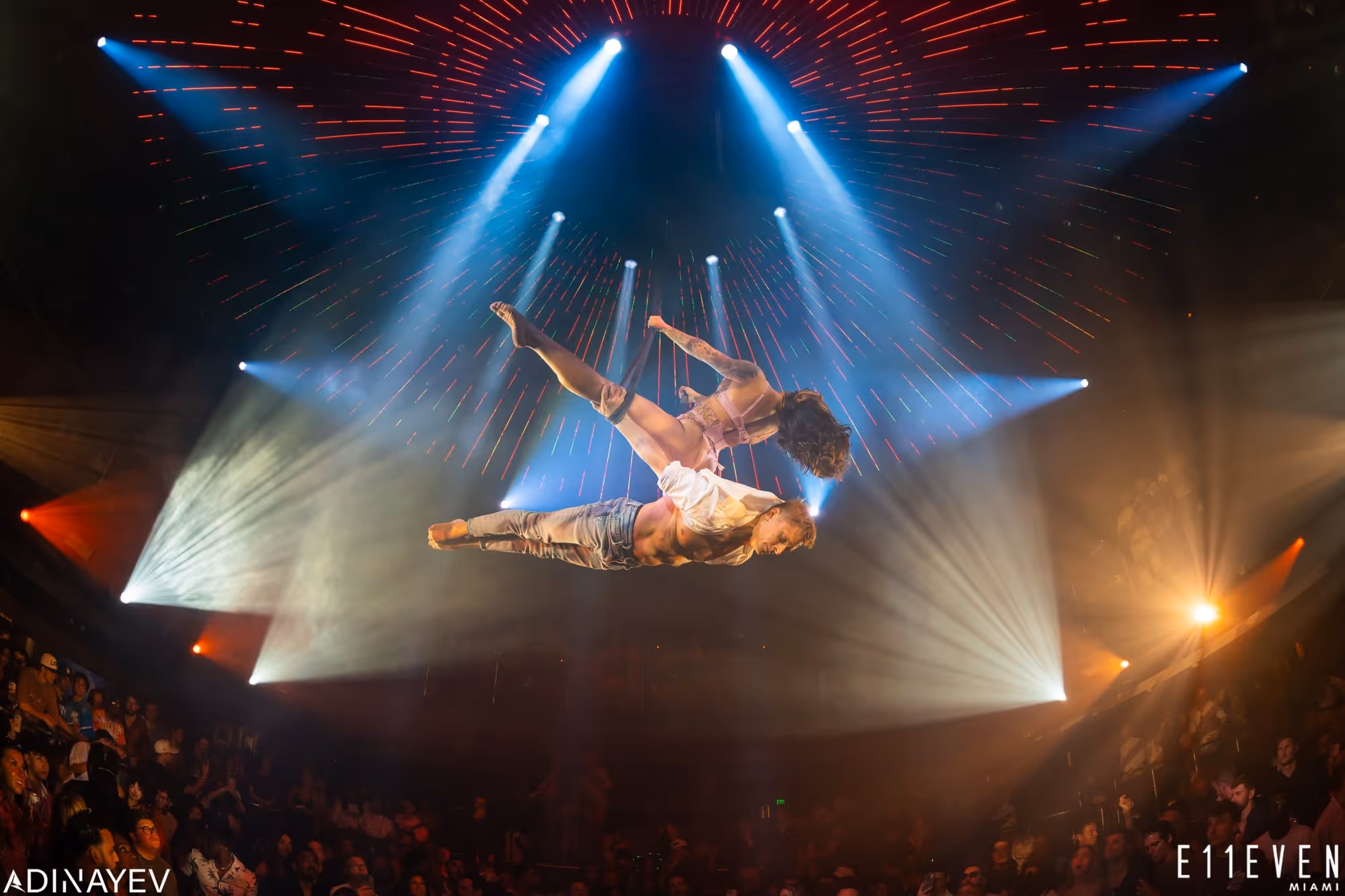 Man and woman doing an aerial performance inside E11EVEN