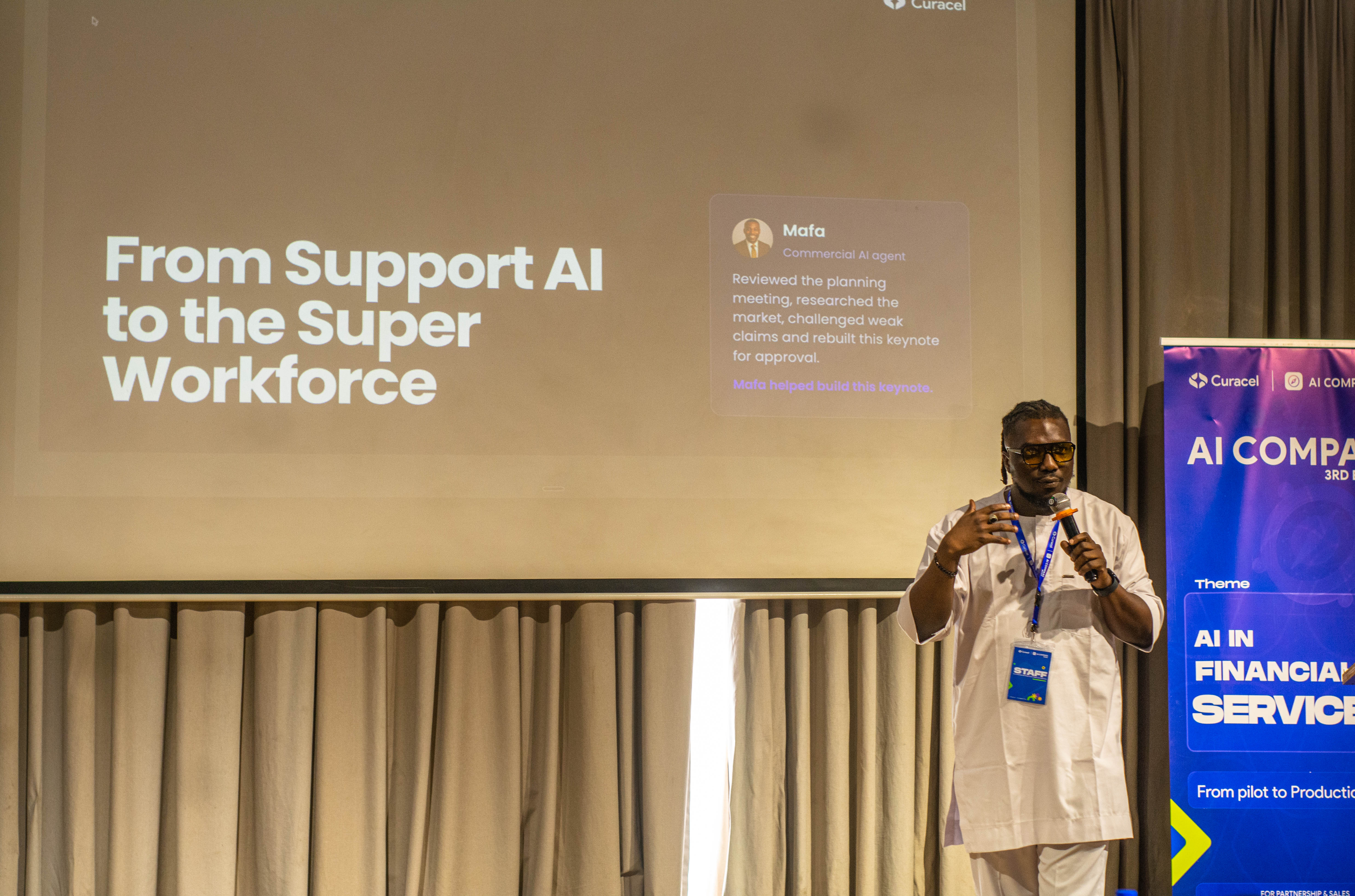 A presenter at AI Compass Lagos 2026 speaking beside a slide titled From Support AI to the Super Workforce.