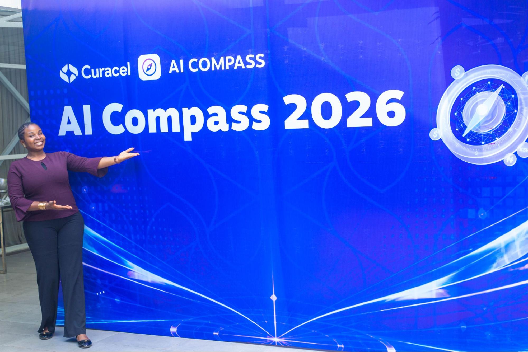 An attendee gesturing towards the blue Curacel AI Compass 2026 event backdrop.