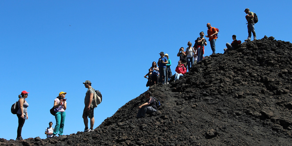 Team climbing Etna mountain in Sicily