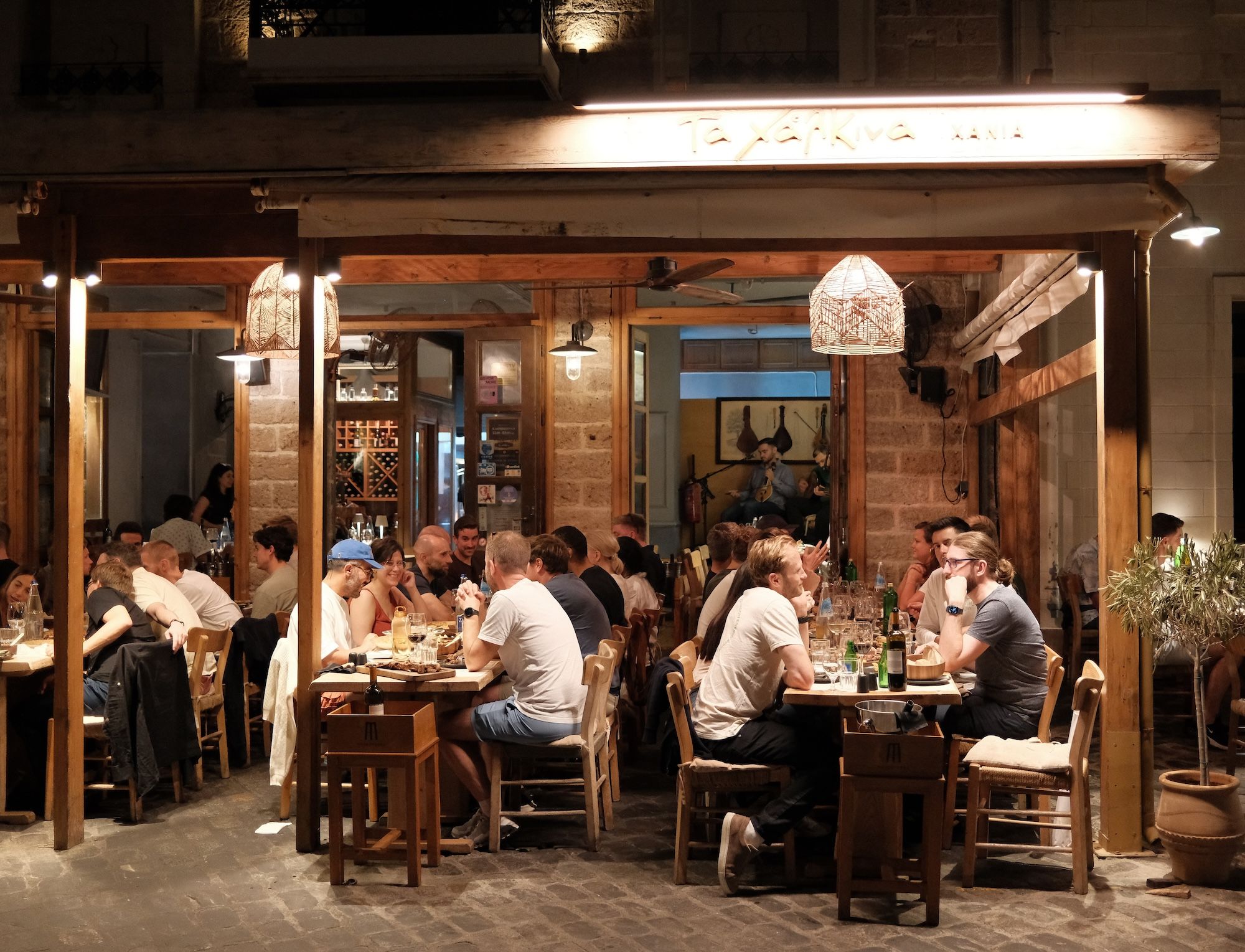 Greek tavern dinner with live music by the sea during a corporate retreat