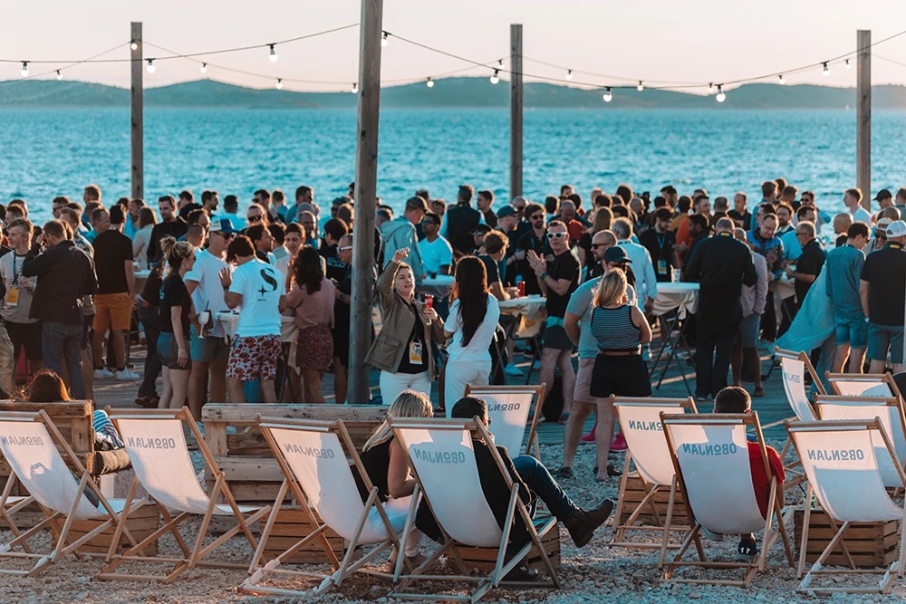 Team enjoying sunset drinks together during a company retreat