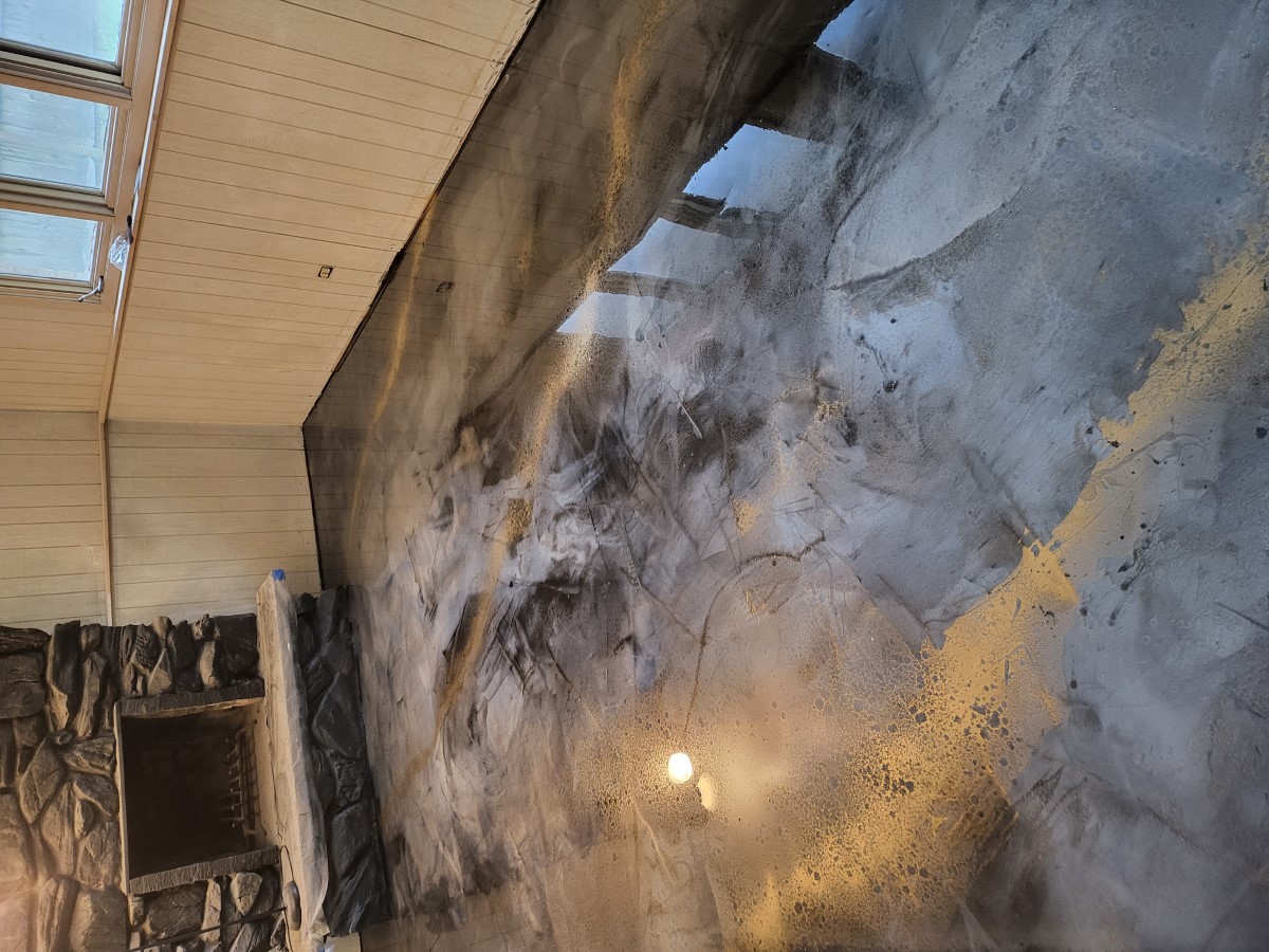 Polished metallic epoxy floor reflecting the room