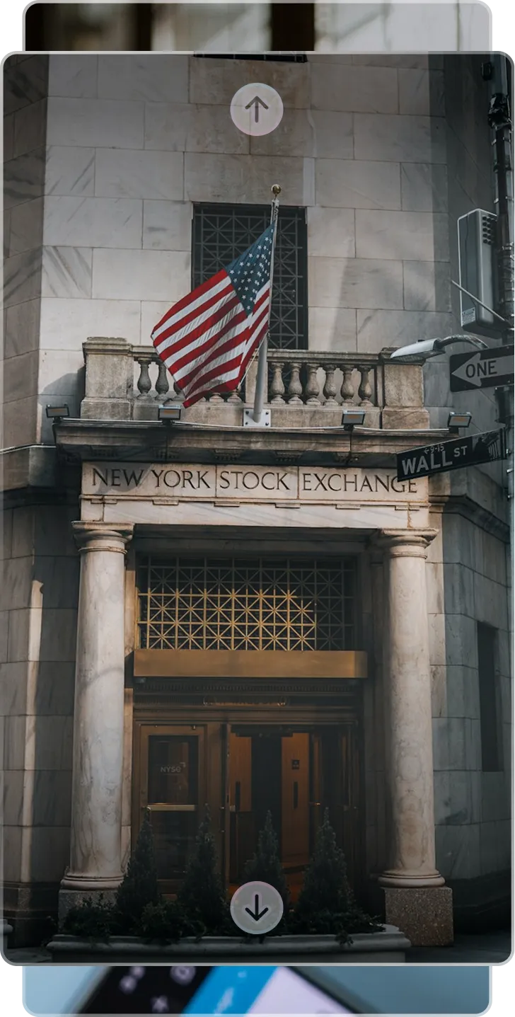 Historic building entrance featuring classical columns, ornate wooden doors, and US flag above.