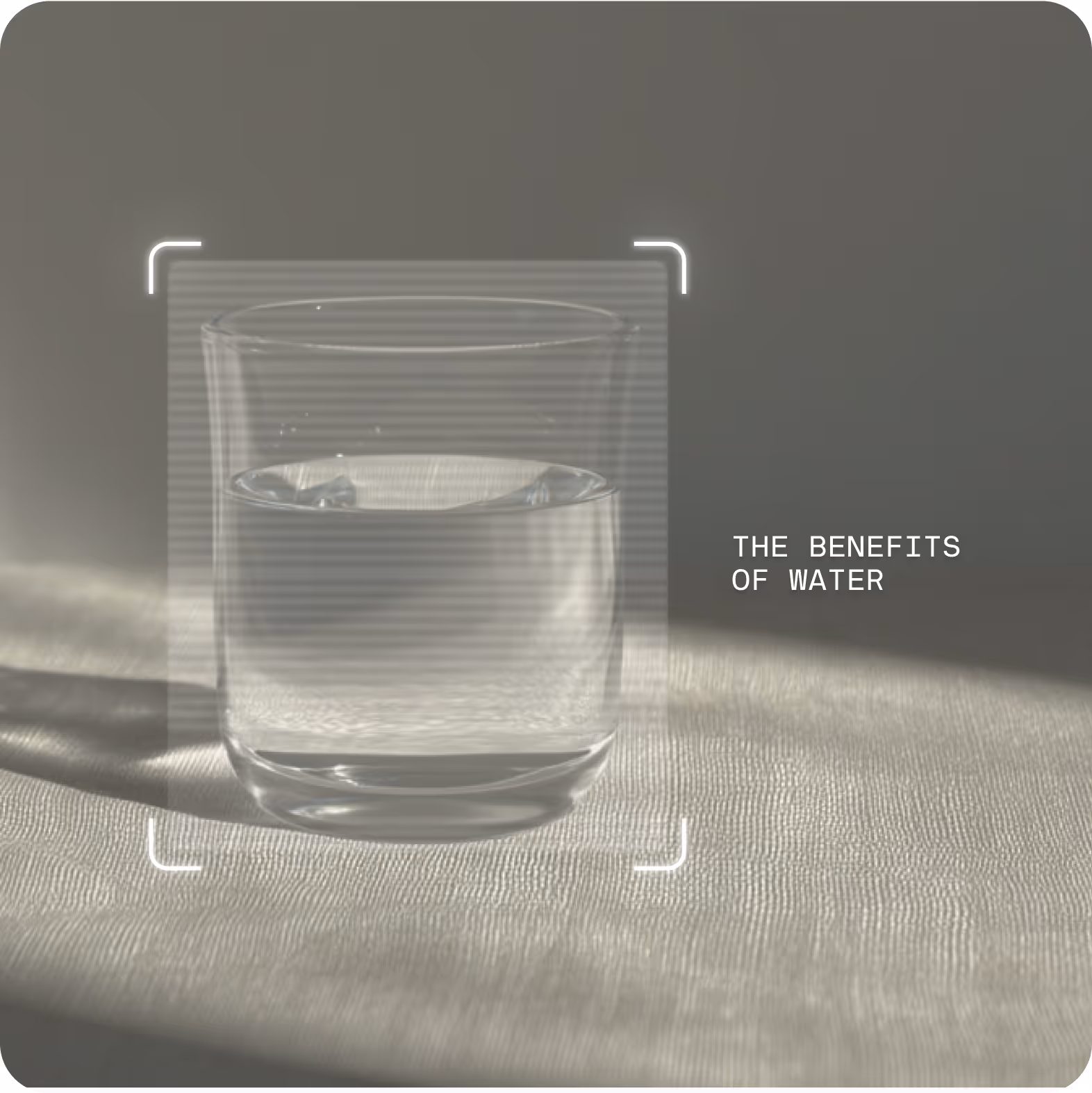 A glass of water is on a table, with text reading "The benefits of water."