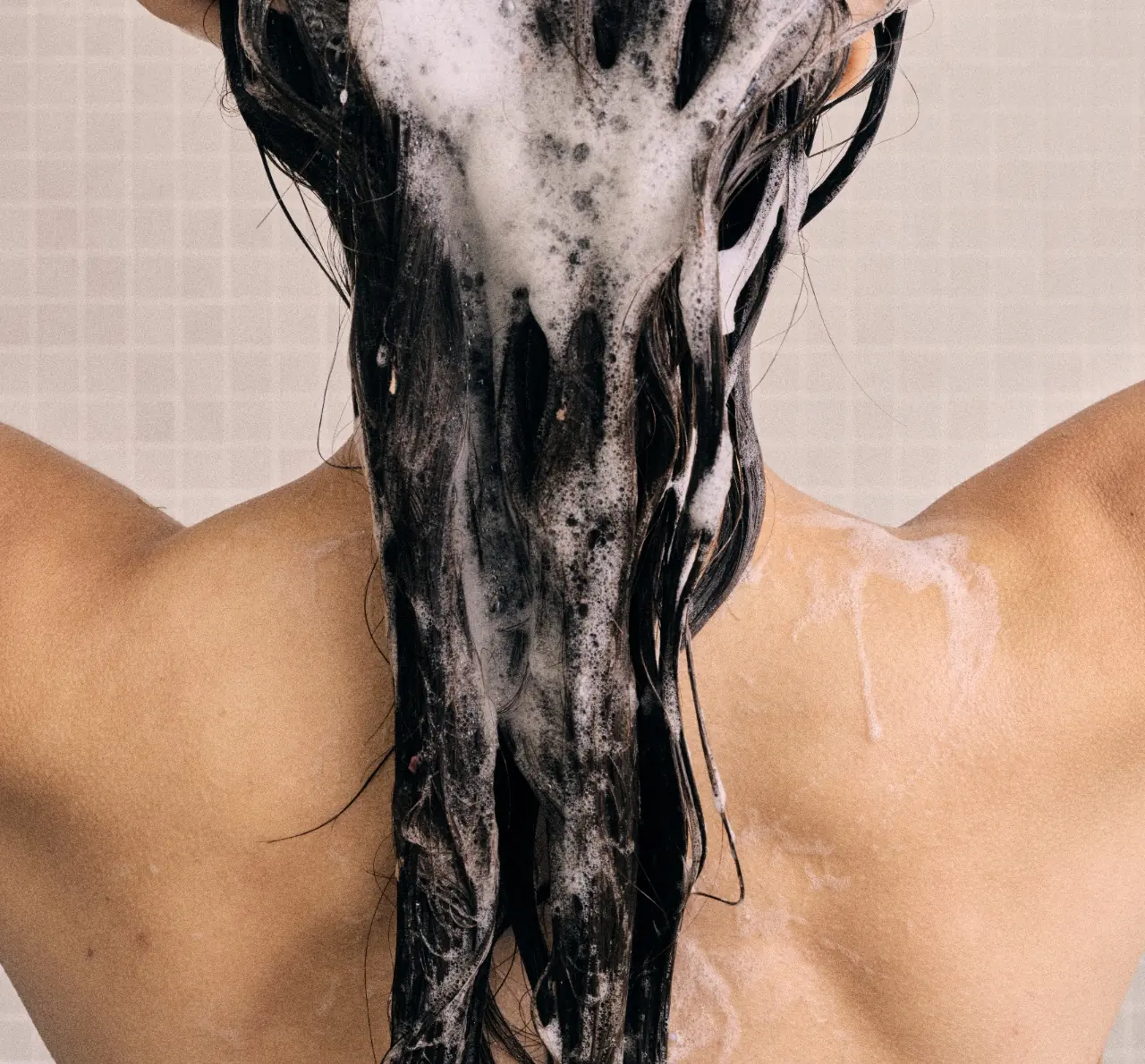 Woman washing her hair in the shower