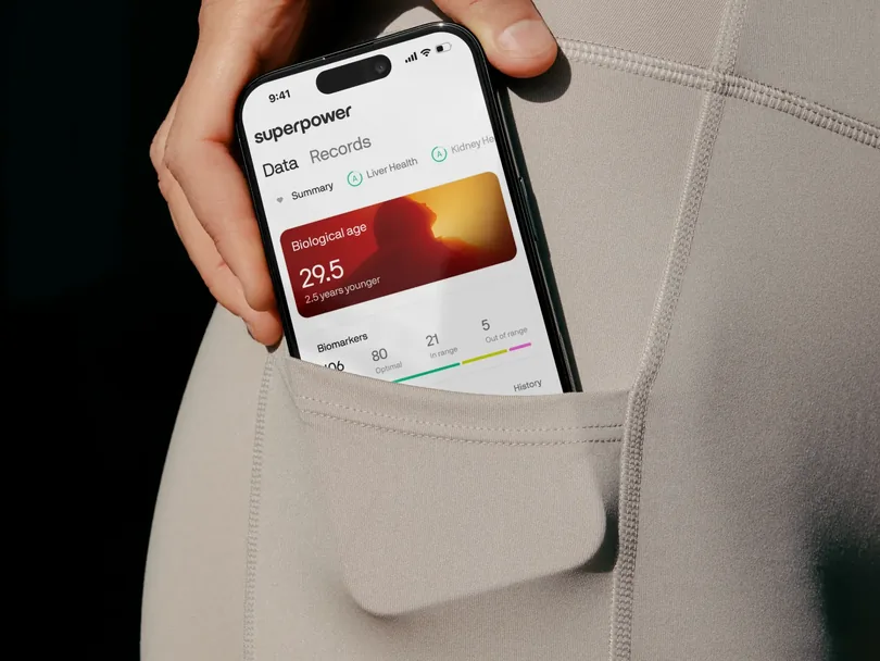 Phone showing the Superpower app tucked into a leggings pocket