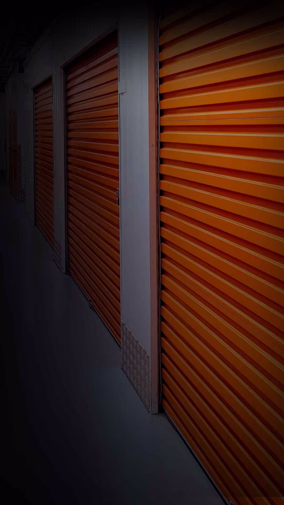 A lit corridor of storage units at the Experia storage facility