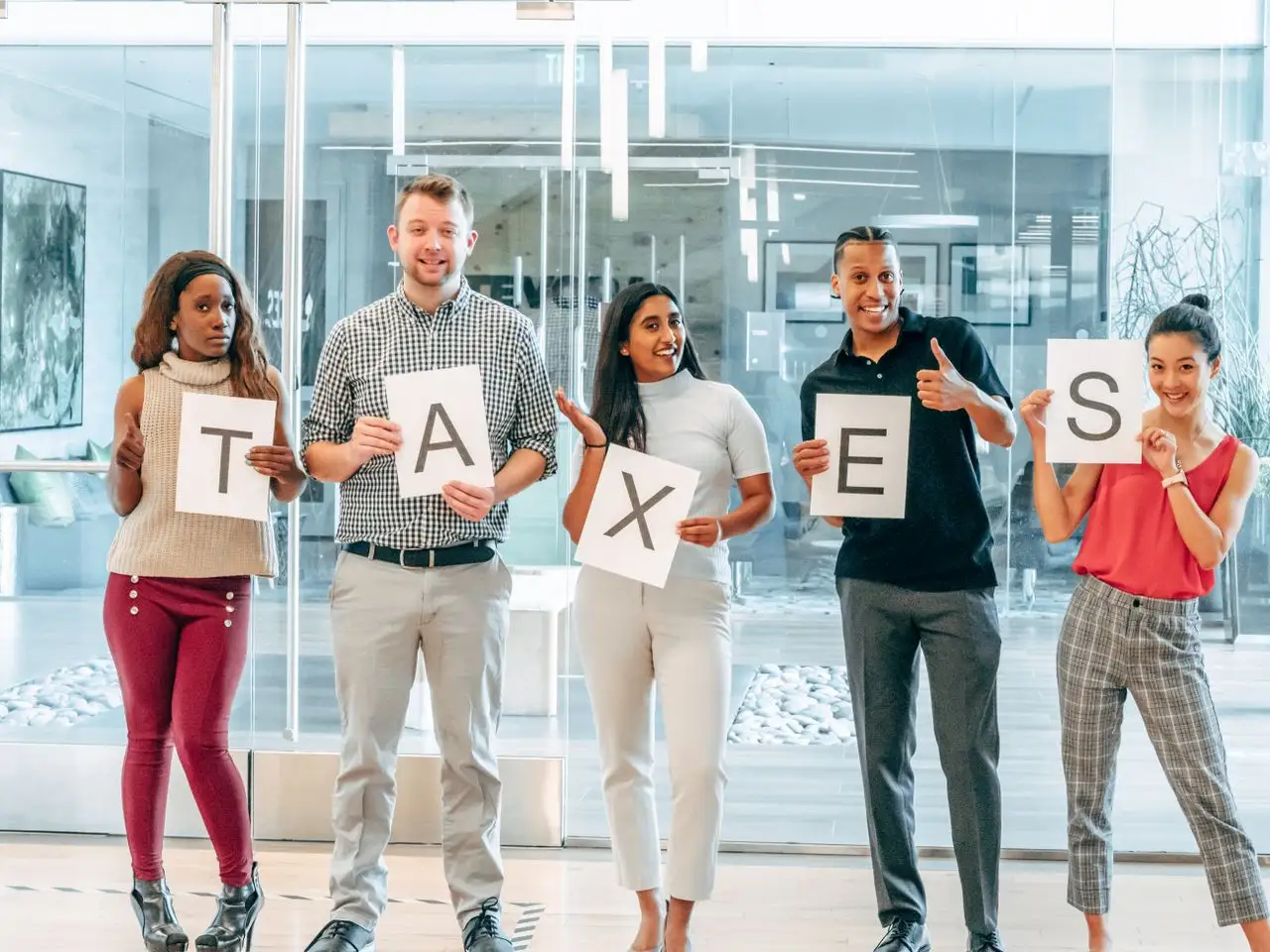 group of people holding a taxes sign