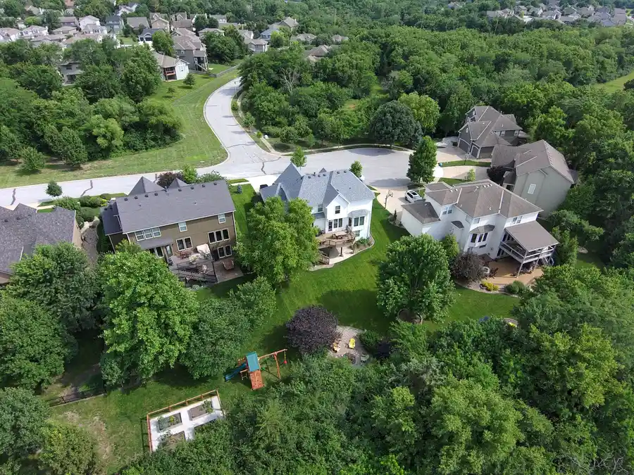 Aerial view of a wooded suburban neighborhood in Olathe, Kansas