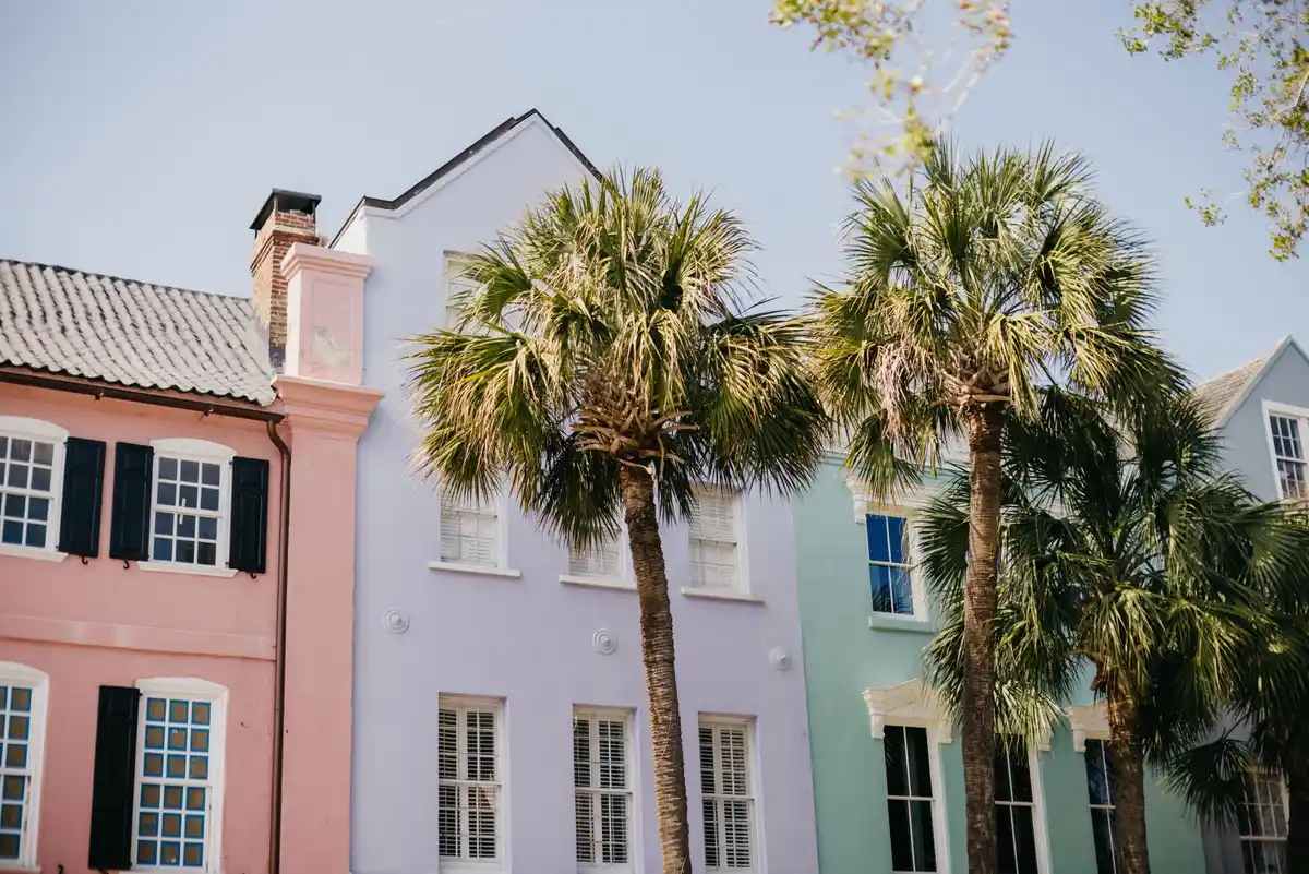 Pastel-colored historic row houses with palm trees in Charleston, South Carolina
