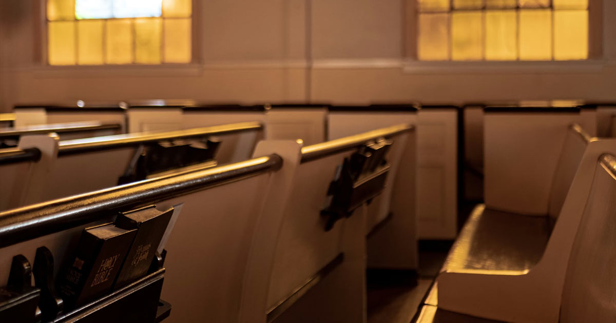 A row of white church pews