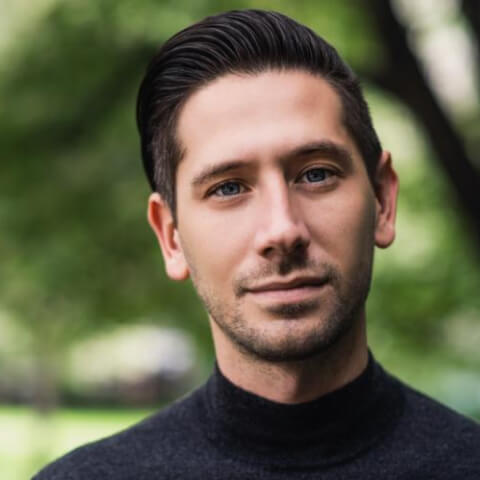 A close up of a person wearing a turtle neck sweater