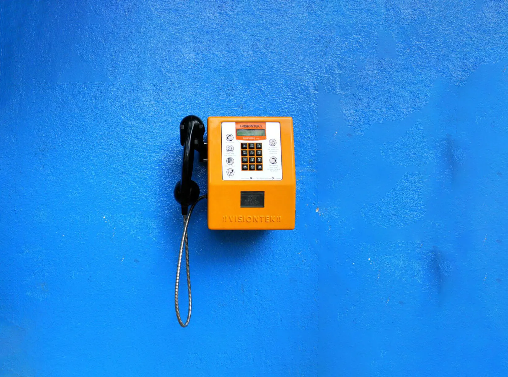 Indian payphone on a blue wall