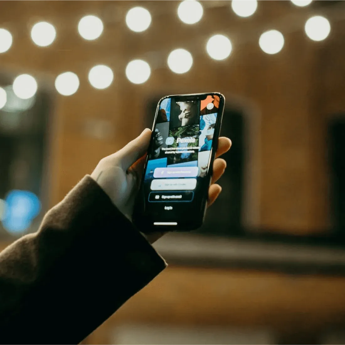Hand holding and showing an app