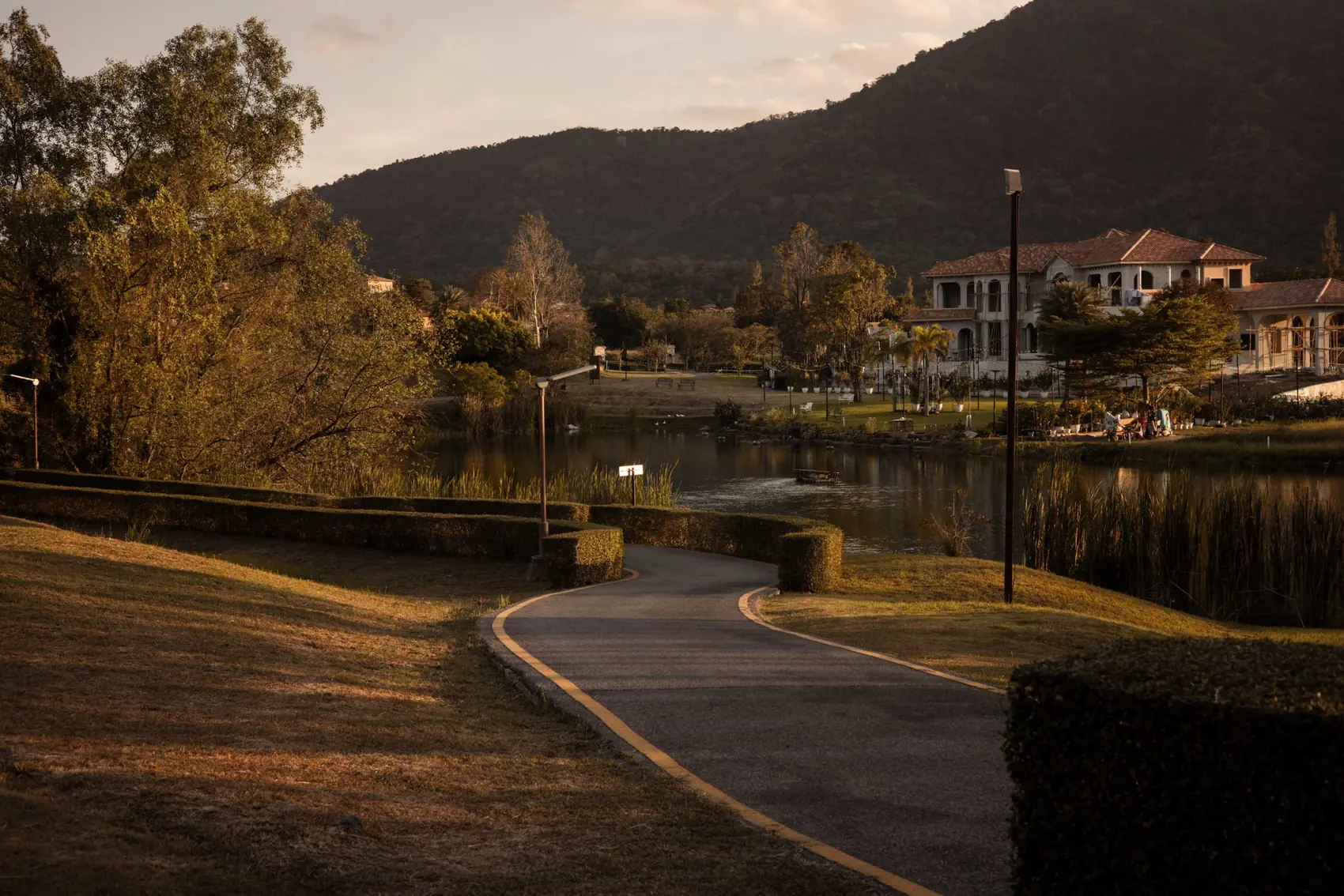 A winding path beside the lake, with the mountain behind.