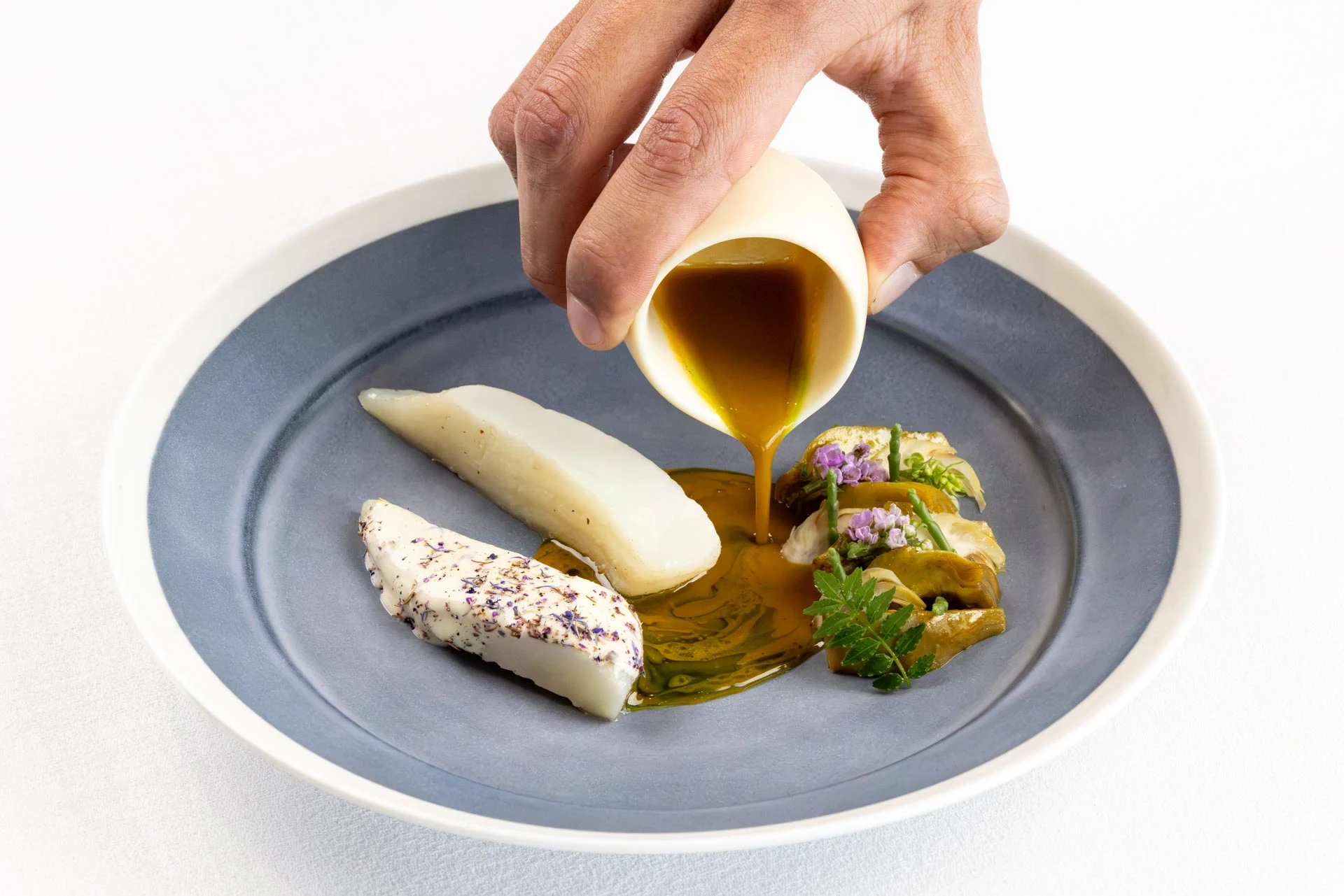 Sauce poured onto a plated dish at BLUE.