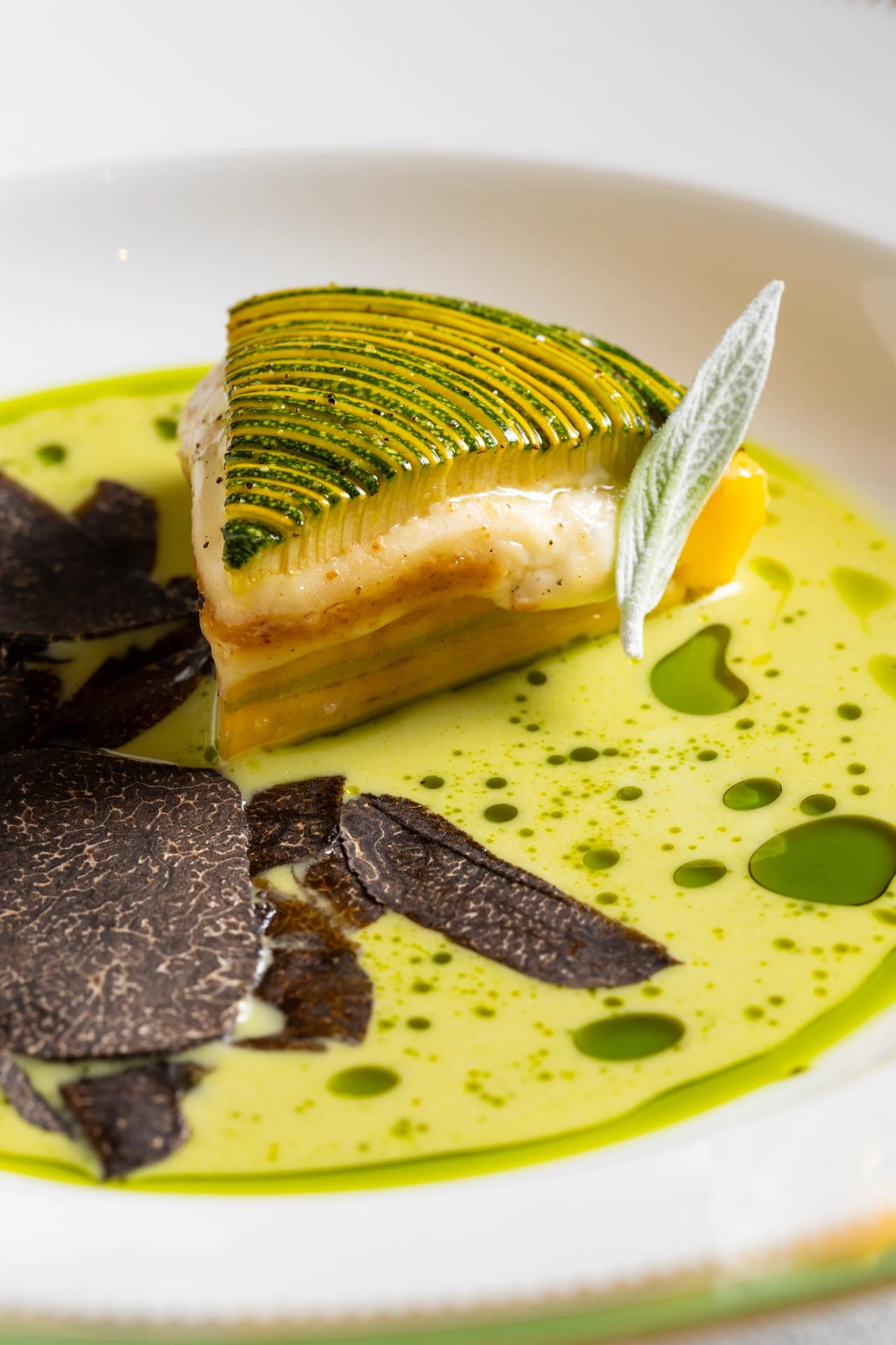 A finished dish with layered vegetables and green sauce at BLUE.